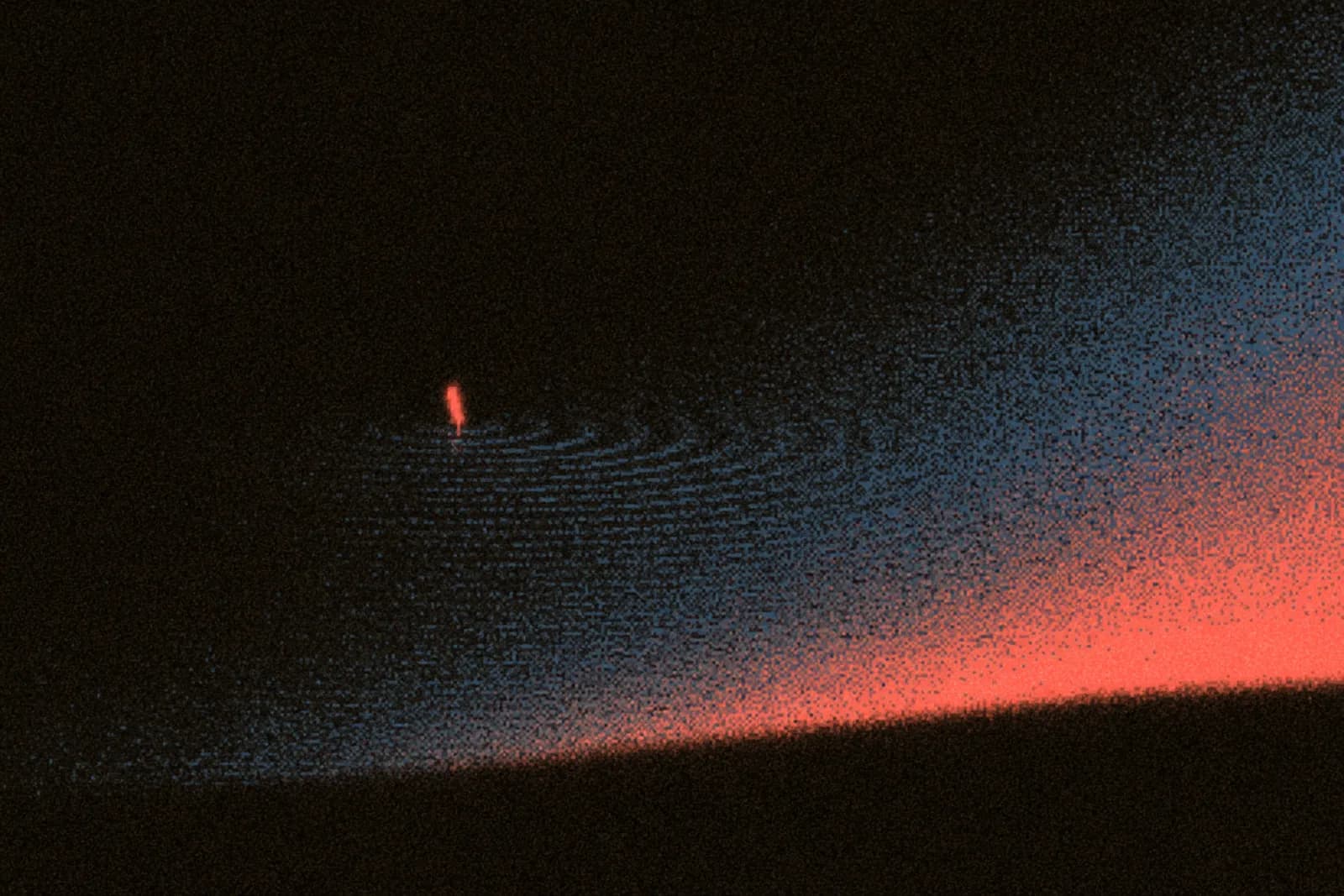 A lure breaking the water surface at dusk