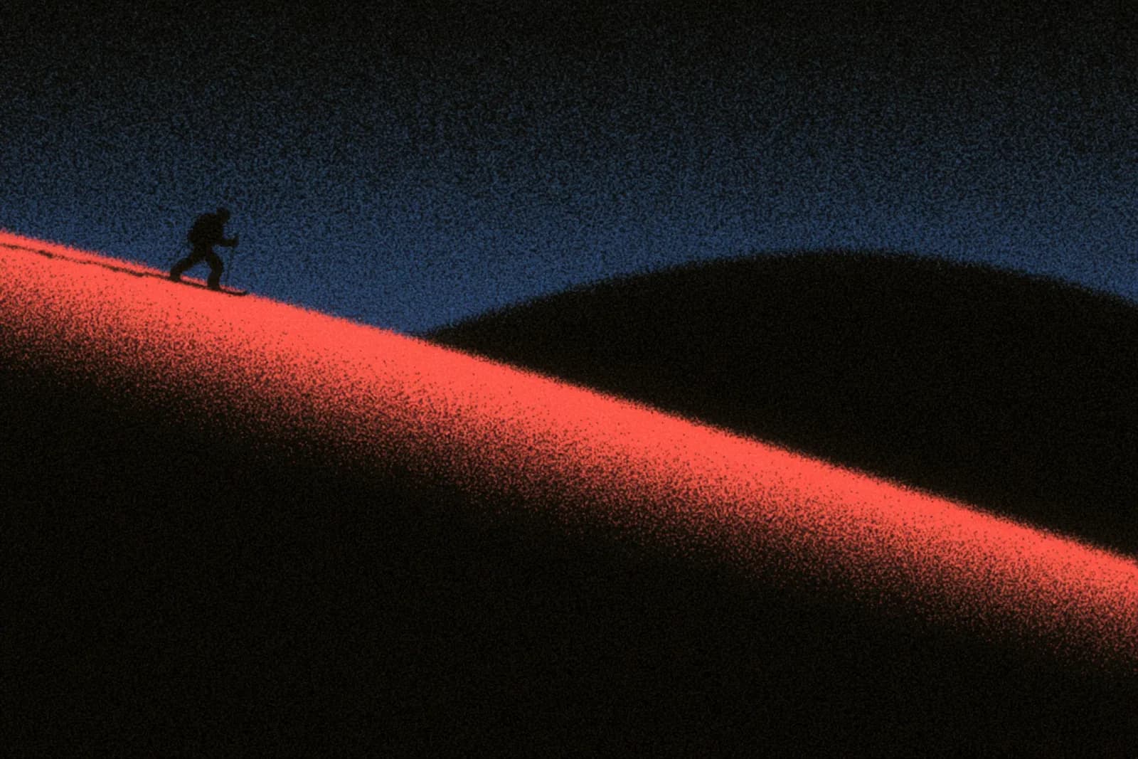 A splitboarder skinning up a ridge at dawn